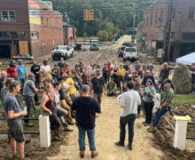 App State alumnus Forrest Gilliam ’08, GROW NC legislative director, second from right in foreground, addresses community members in downtown Marshall following Hurricane Helene. Photo courtesy of GROW NC