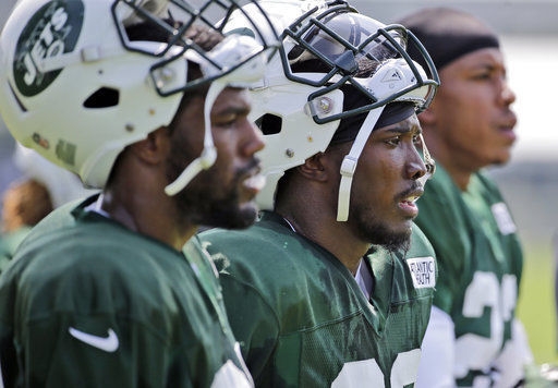 New York Jets' Doug Middleton (center) looks at the field during practice at the NFL football team's training camp in Florham Park, N.J.