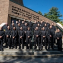 The 24 graduates of the Appalachian Police Academy’s sixth class are pictured with App State Director of Public Safety and Chief of Police Andy Stephenson, far left in second row, App State Police Capt. K.C. Mitchell, far left in first row, and App State Police Officer Tina Dunn, far right in first row, on the steps of App State’s Rosen Concert Hall. From left to right, top row to bottom row, are April Gunter, Drew Van Hise, Jonathan Flores, Jacob Lowe, Timothy Fitzgerald, Isaac Holliday, Anderson Ray, Blai