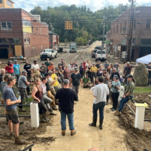 App State alumnus Forrest Gilliam ’08, GROW NC legislative director, second from right in foreground, addresses community members in downtown Marshall following Hurricane Helene. Photo courtesy of GROW NC